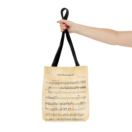 Model holds tote bag with sheet music of Verdi's Triumphal March from Aida - Size small